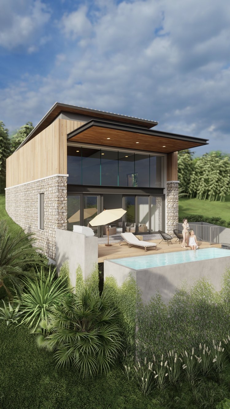 Modern house with large glass windows, wooden and stone exterior, outdoor patio with lounge chairs, umbrella, and a small pool, surrounded by lush green plants and trees.