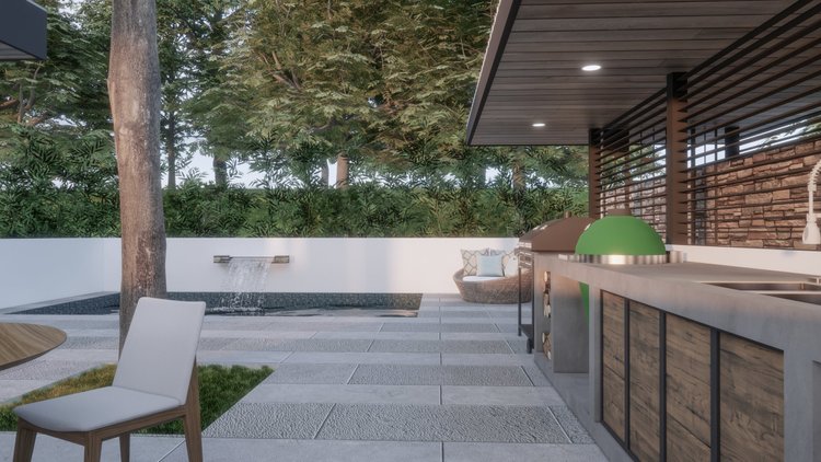 Outdoor patio with a tree, a small waterfall feature, modern seating, and a kitchen area with a grill and green cover, surrounded by lush greenery and brick walls.