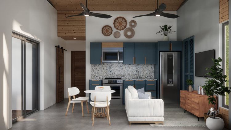 Modern living space with an open-concept kitchen and dining area. Blue cabinets, gray speckled backsplash, stainless steel refrigerator, microwave, oven, and black sink. White armchair with blue and white pillows, wooden sideboard, large flat-screen 