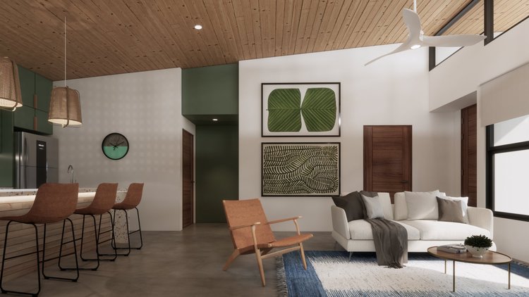 Modern living room with white sofa, wooden armchair, coffee table, large window, wall art of green leaves, white and gray pillows, ceiling fan, and kitchen area with bar stools and pendant lights.